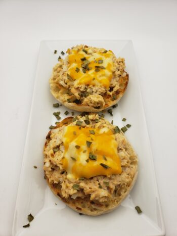 Image of Ferrigno salmon in water on toasted english muffin with melted colby jack cheese